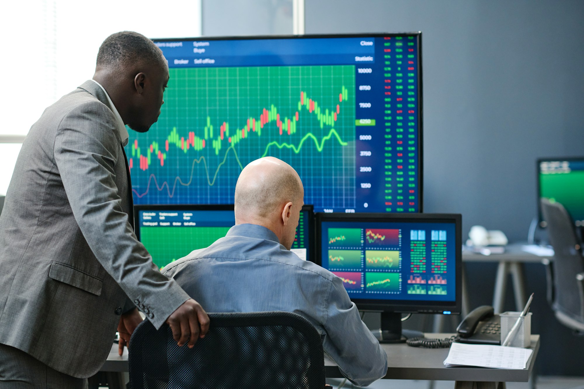 Two Men Working With Trading Charts